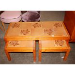 A nest of three teak and tile top coffee tables, t