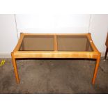 A light Ercol coffee table, fitted two section smo