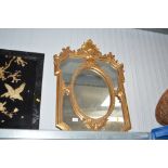 A gilt framed decorative wall mirror