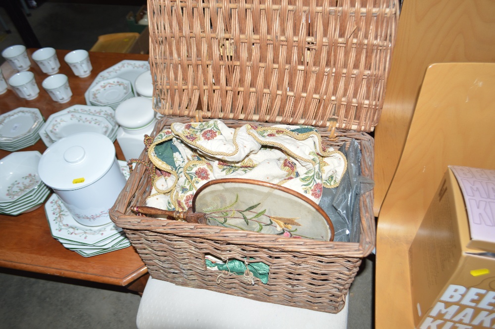 A wicker basket and contents of various cushion co