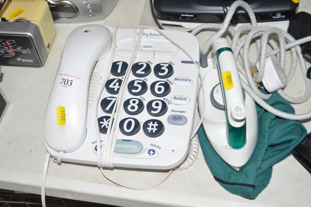 A travel iron together with a big button phone