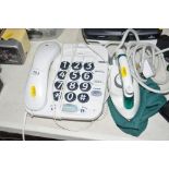 A travel iron together with a big button phone