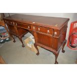A large sideboard raised on claw and ball supports