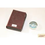A small glass paperweight and a post-card album co