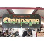 A double sided sign "Celebrate With Champagne" and