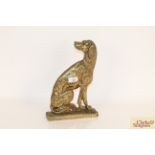 A brass door stop in the form of a seated hound