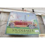 A tin advertising sign for "Studebaker Builder of