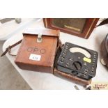 An AM volt meter in leather travelling case and a