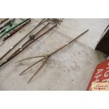 A vintage wooden three pronged hay fork