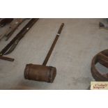 A large metal bound wooden mallet