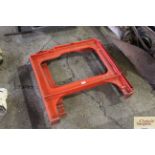 Two red painted iron workbench ends