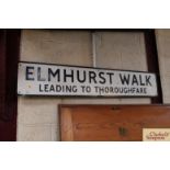 A metal street sign "Elmhurst Walk, Leading To Tho