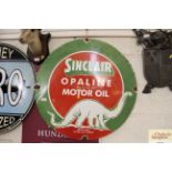 A circular enamel advertising sign for "Sinclair O