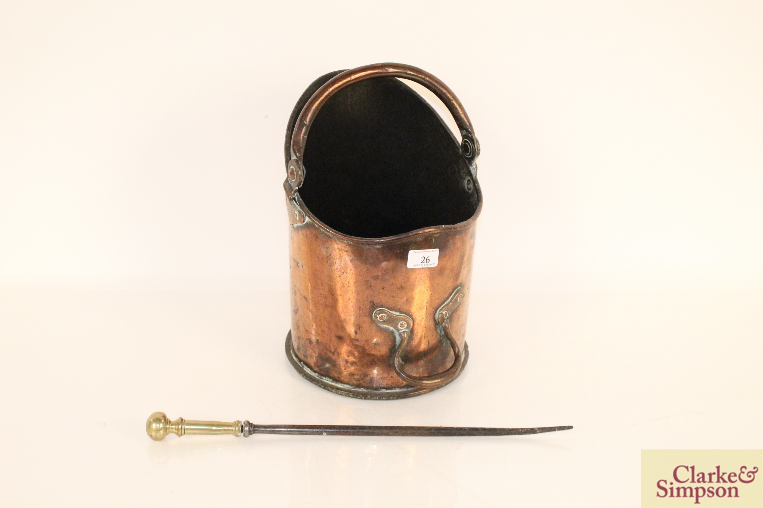 An antique copper coal hod with swing handle and