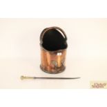 An antique copper coal hod with swing handle and