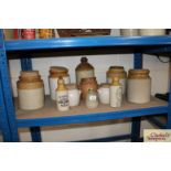 A collection of various stone glazed storage jars