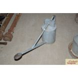 A vintage galvanised watering can with long spout