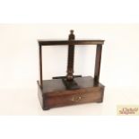 An antique oak screw action book press, fitted sin