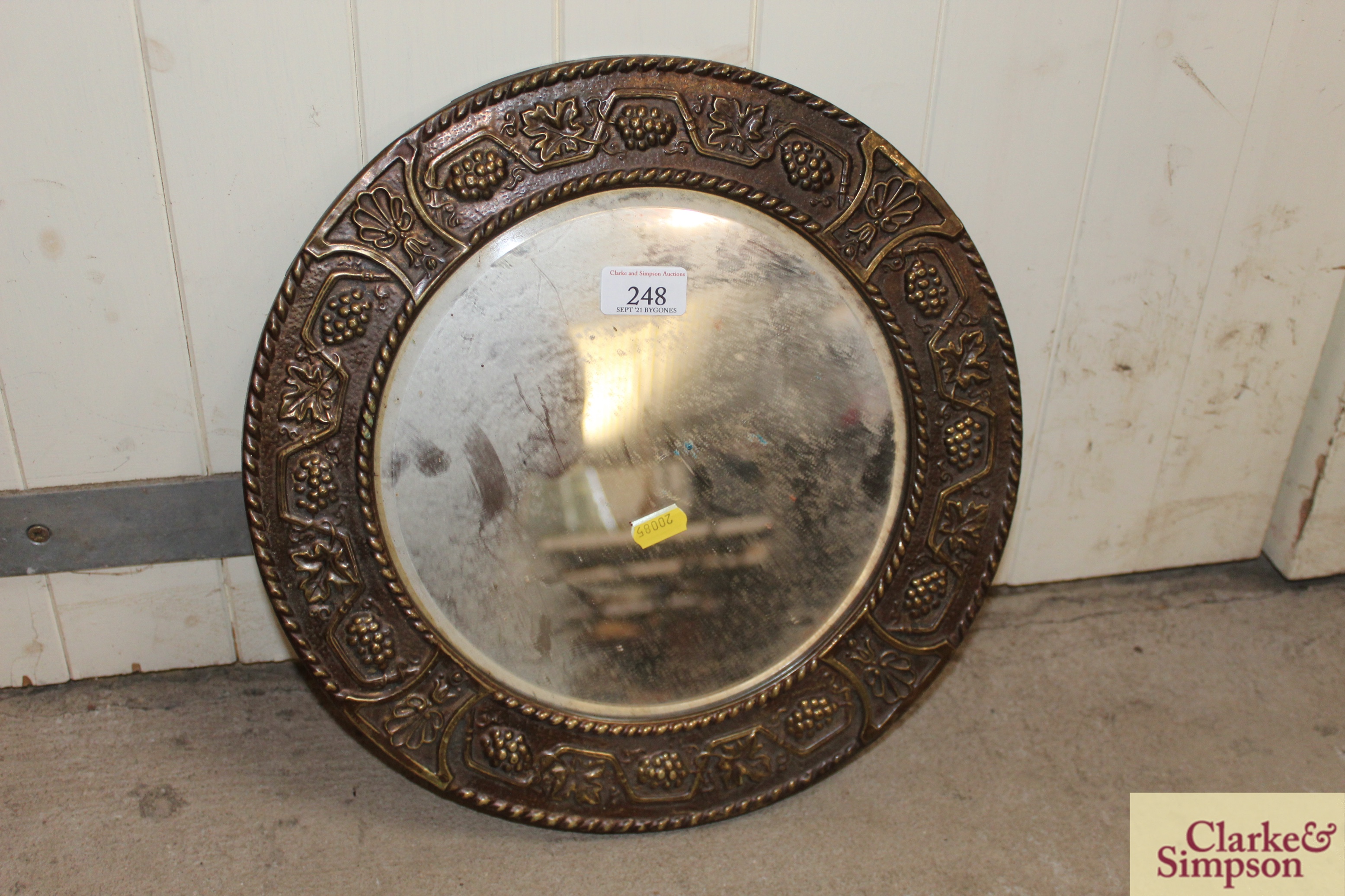 A circular brass framed bevel edged wall mirror wi