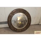 A circular brass framed bevel edged wall mirror wi