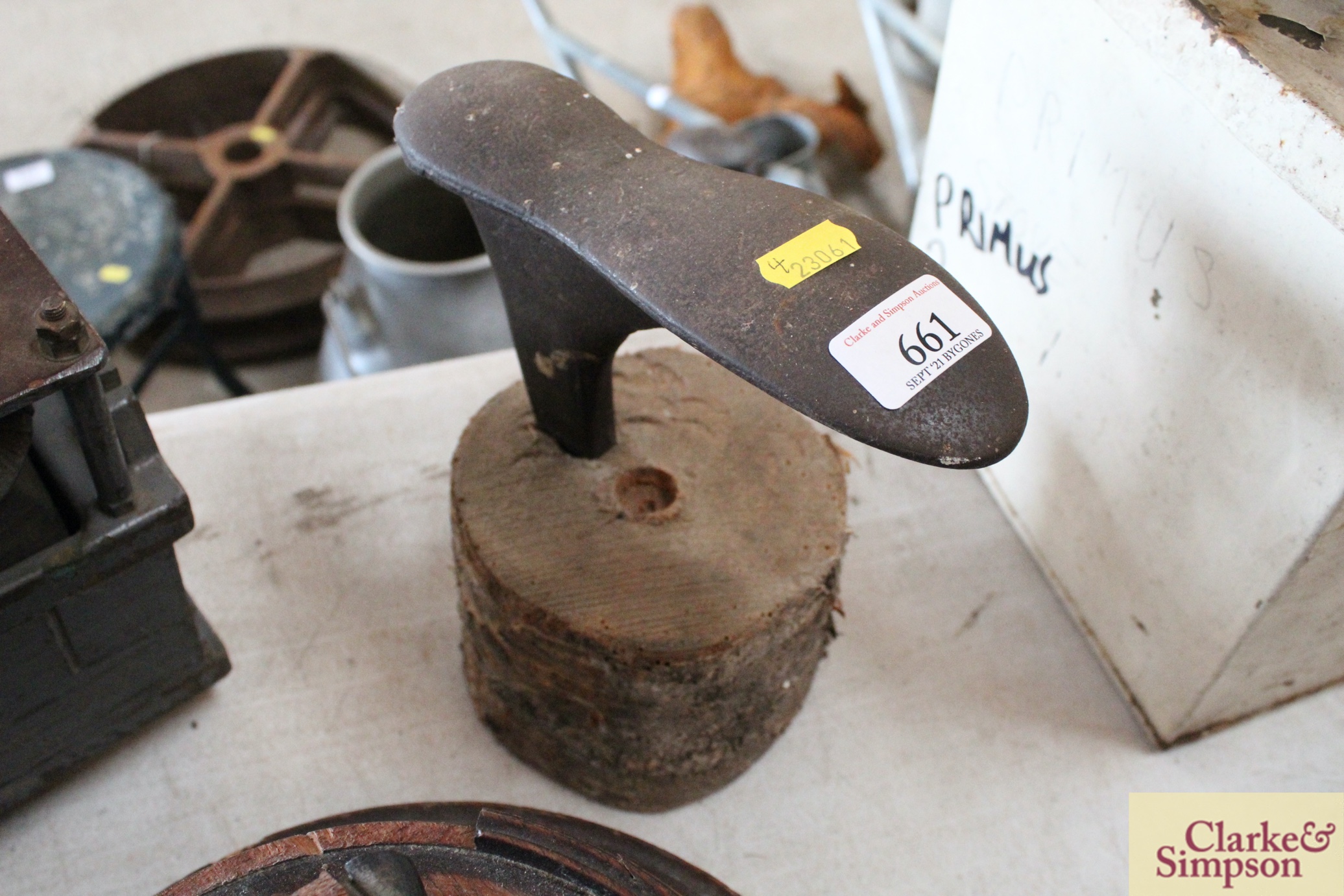 A cobblers shoe last set into a wooden log