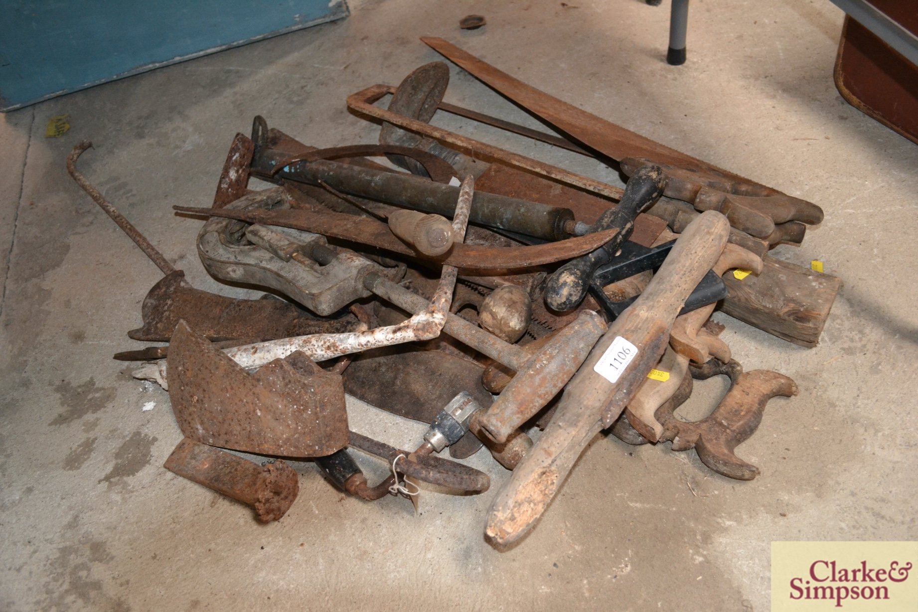 A quantity of saws, stirrup pump, axe heads, other