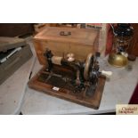 An ornate cased hand sewing machine