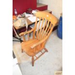 A Victorian elm slat back elbow chair