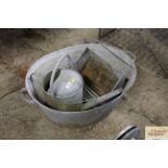 A galvanised twin handled tub, a watering can and