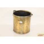 An antique brass coal bucket