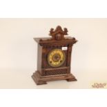 A continental oak cased striking mantel clock