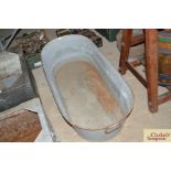 A vintage galvanised twin handled bath