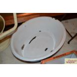 A vintage oval enamel child's bath with flanged ed