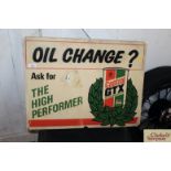 A "Castrol Oil Change" plastic advertising sign, app