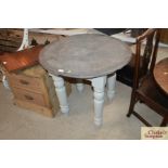 A round slate top conservatory table with painted