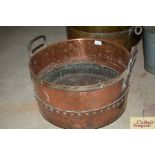 An antique riveted two handled cauldron