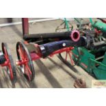 An ornamental replica field cannon with iron wheel