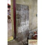An antique pine planked door with iron hinges