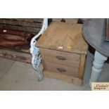 An antique stripped pine ironmongers two drawer ca