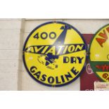 An "Aviation 400 Dry Gasoline" advertising sign, a