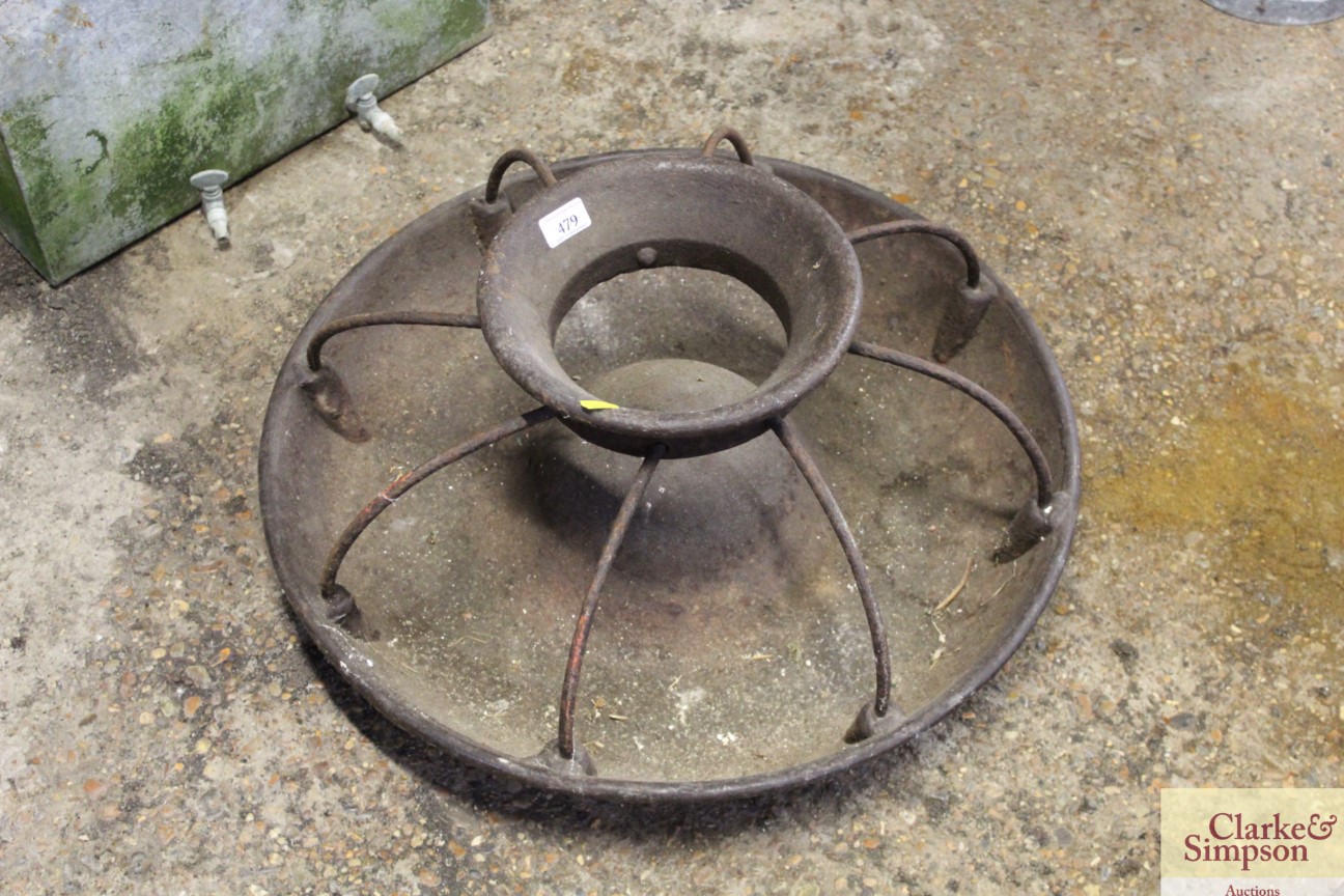 A circular cast iron pig trough