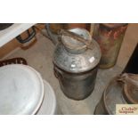 A galvanised and iron tall milk churn and lid