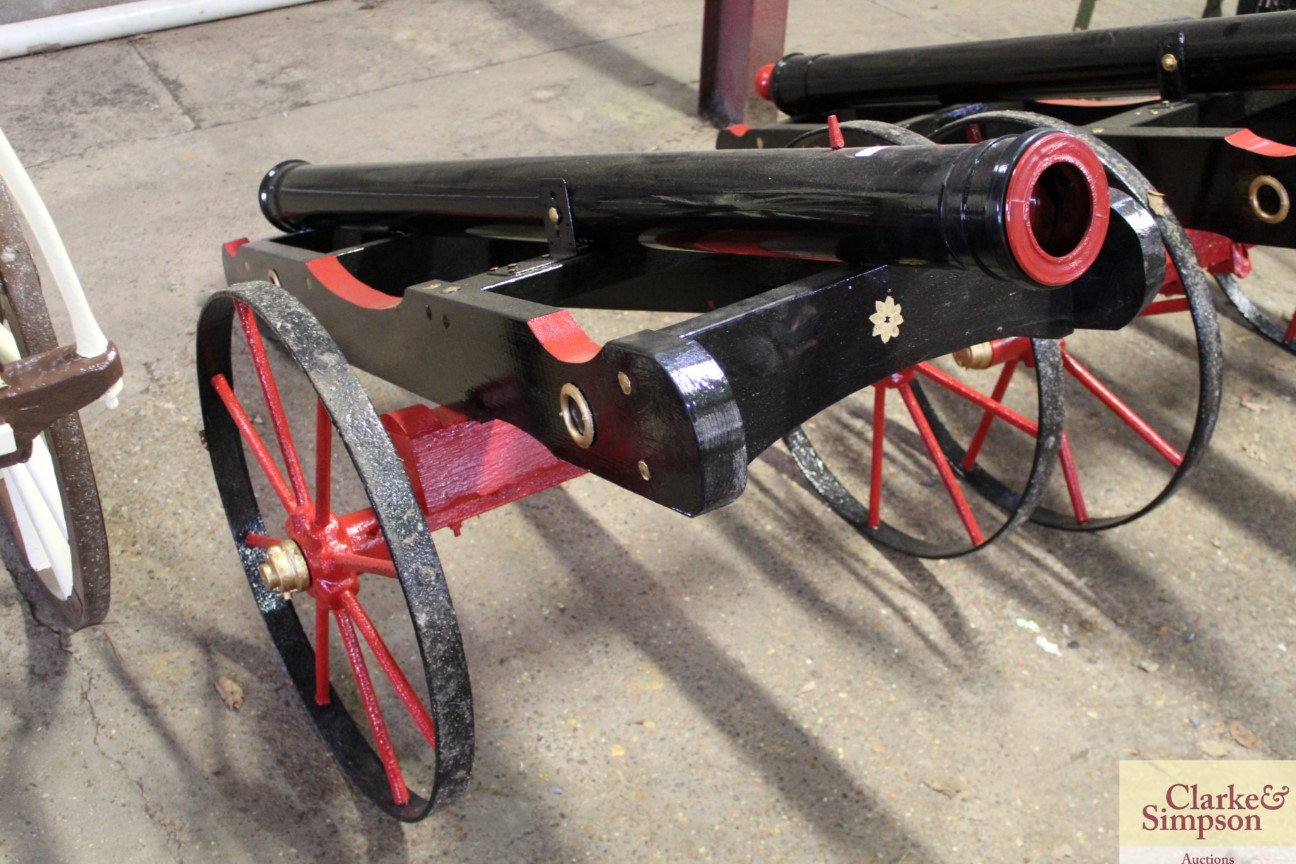 An ornamental replica field cannon with iron wheel