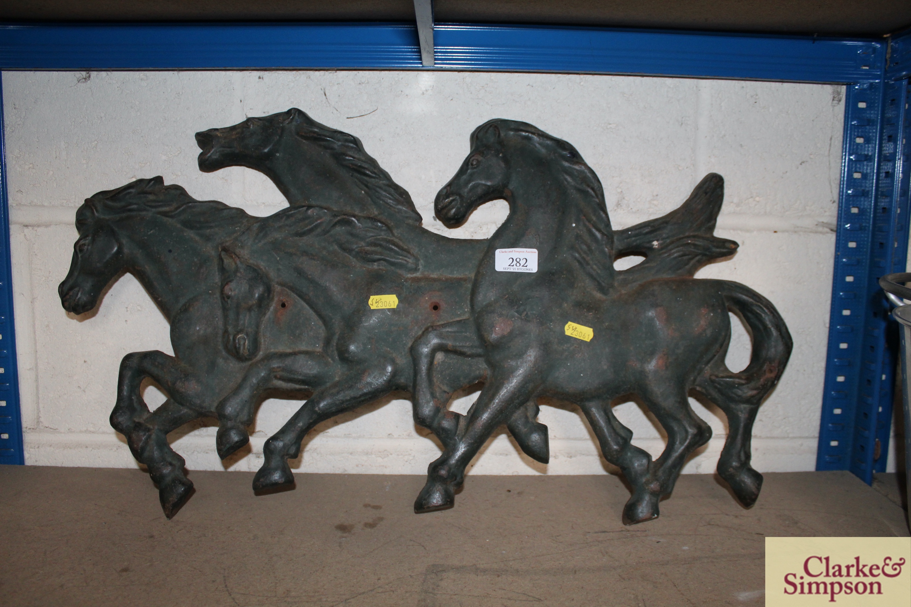 A four horse cast iron wall plaque, 27cm long NB.