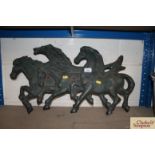 A four horse cast iron wall plaque, 27cm long NB.