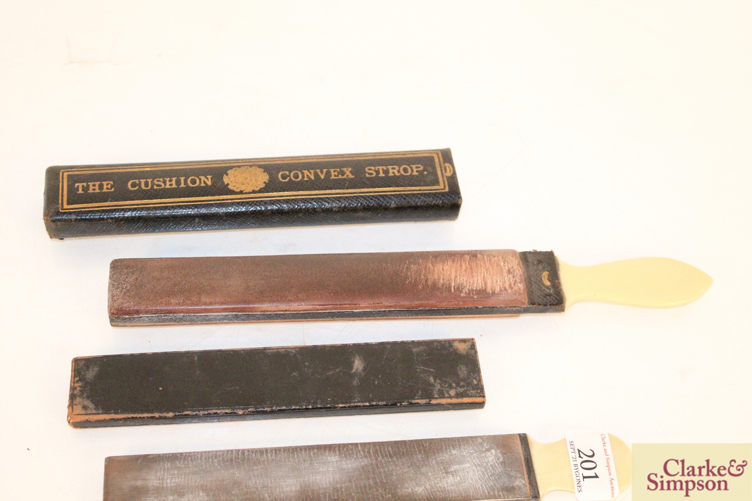 A cushion convex razor strop; a smaller similar an - Image 5 of 5