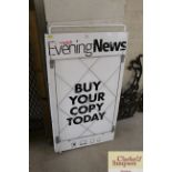 An enamel newspaper advertising stand for The Norw
