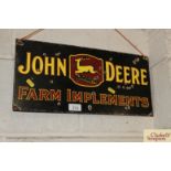 An enamel "John Deere Farm Implements" advertising