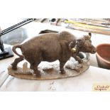 A carved wooden figure of a buffalo (one horn chip