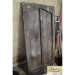 An antique oak door with arched panel